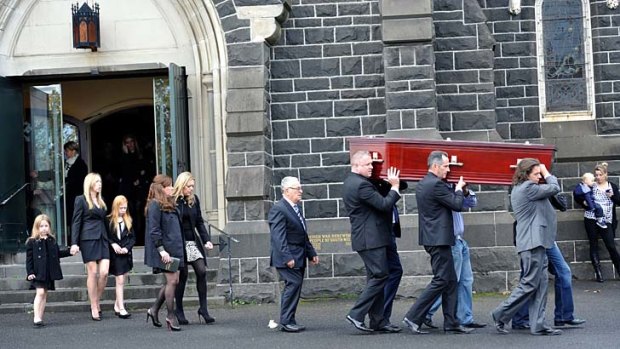 A friend of the force: Mourners follow the casket of Raymond Bartlett as it is carried from the church.