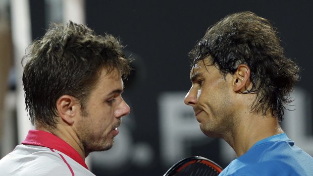 Stan Wawrinka and Rafael Nadal embrace at the net after their match.