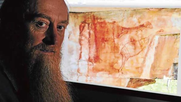 Robert Gunn works on what could be a painting of an emu-like bird that died out 40,000 years ago. The bird in question is the larger one, on the left.
