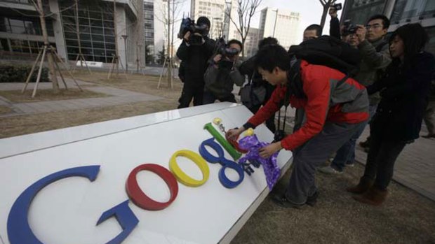 A man places flowers on a Google logo in front of its China headquarters building in Beijing in March.