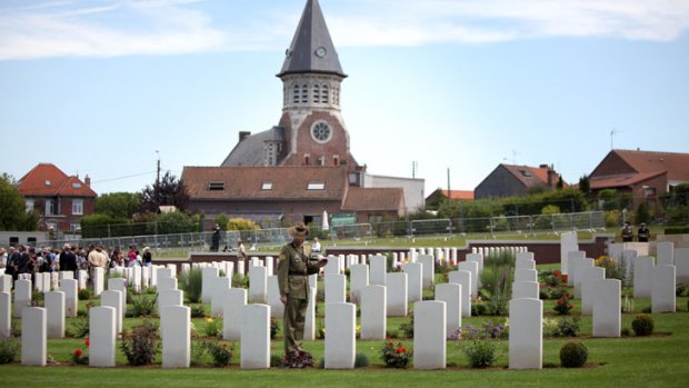 A lone Australian soldier inspects the cemetery at Fromelles, where the bloody military battle began 96 years ago today. With 5533 AIF casualties in a single night, it remains the worst 24 hours in Australian war history.
