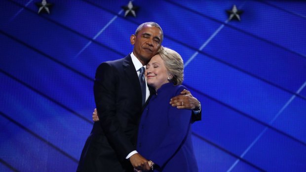US President Barack Obama hugs Democratic presidential nominee Hillary Clinton, on stage during the Democratic National Convention.