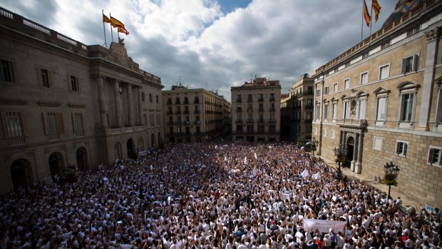 People gather in Sant Jaume square in Barcelona as a simultaneous rally in Madrid also called for dialogue amid a political crisis caused by Catalonia's secession push.