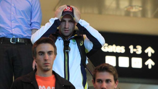 Facing the music ... Phillip Hughes couldn't hide his distress as he arrived back in Sydney yesterday following a nightmare two-Test series against New Zealand.