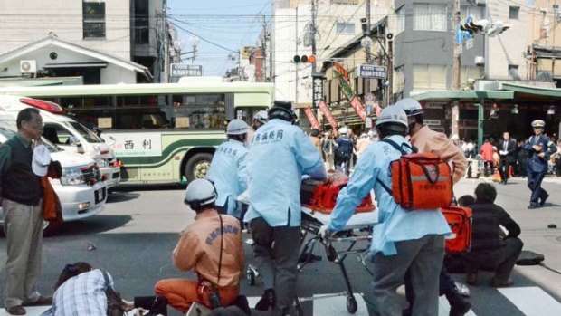 Tragedy ... medical personnel tend to the injured pedestrians in Kyoto.