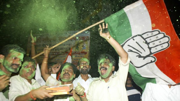 Green light: Congress Party activists celebrate and wave the party's flag after the coalition Government won the confidence vote in parliament. PICTURE: AP