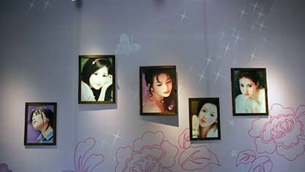Pictures of young women hanging on a wall at the newly opened Special Tea House Museum.