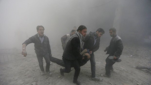 Residents carry an injured man on Monday after air-strikes by forces loyal to the Assad regime. Hackers loyal to the regime have apparently stolen a trove of sensitive information, including tactical battle plans, from the rebels.