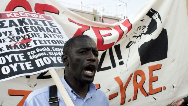 Members of anti-racist organisations and migrants protest outside the high-security prison near Athens.
