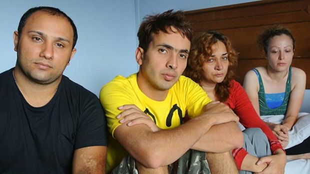 Benyamin Saber (centre), 28, with some of the other 46 Iranian asylum seekers at the  hotel in Merak, Indonesia, where they are being detained after being rescued 110 nautical miles off Christmas Island.