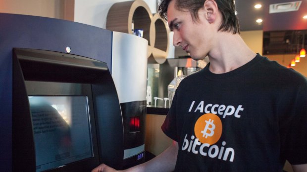 Gabriel Scheare uses what is claimed to be the world's first bitcoin ATM at Waves Coffee House in Vancouver, Canada.