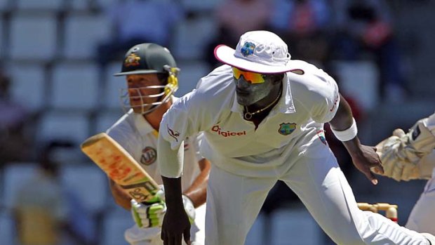 Taking cover ... West Indies captain Darren Sammy scurries out of the way as Ponting plays a pull shot. The former Australian captain batted beautifully for 57.