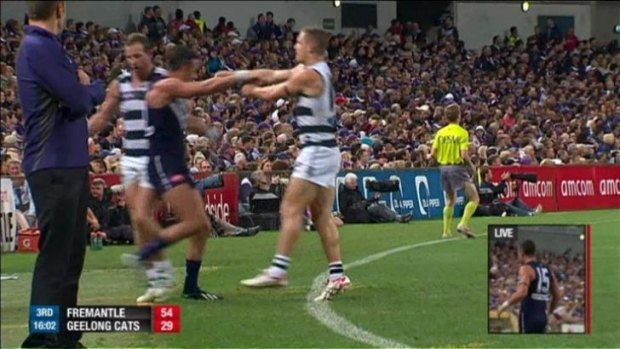 Caught out: Steve Johnson drags Ryan Crowley from the field.