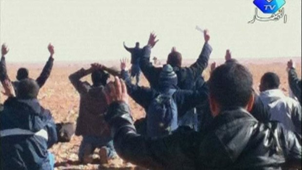 Hostages put their hands in the air at the In Amenas gas facility in Algeria during the seige in January.