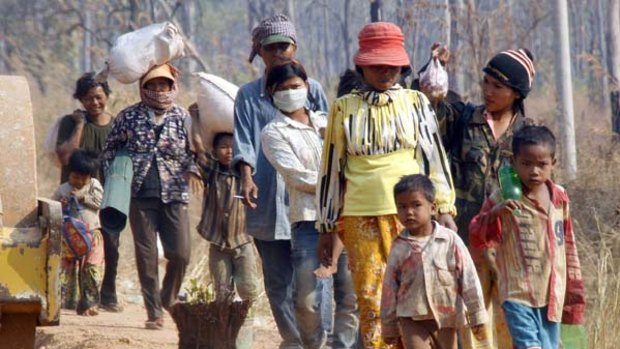 Caught in the crossfire ... Cambodian villagers flee their homes.