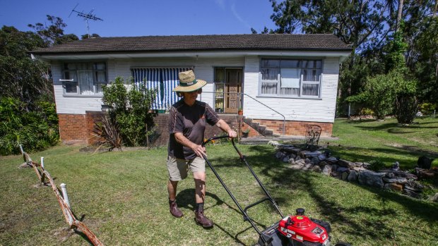 David Blakey, who mows lawns for a living, at a property on Sydney's Northern Beaches. 