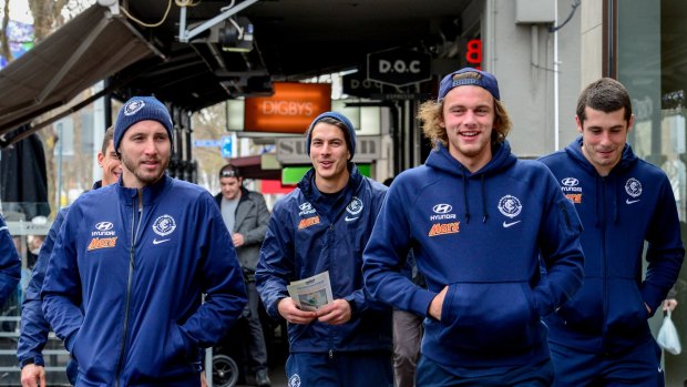 Lygon Street limbo: While the search for a new coach goes on, Blues players promote the AFL's multicultural round in Carlton.
