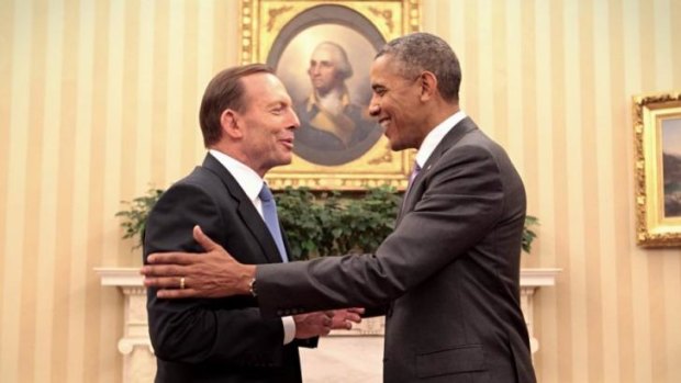 Shaking on it: Abbott and Obama agree to step up defence agreements as the Iraq crisis looms.