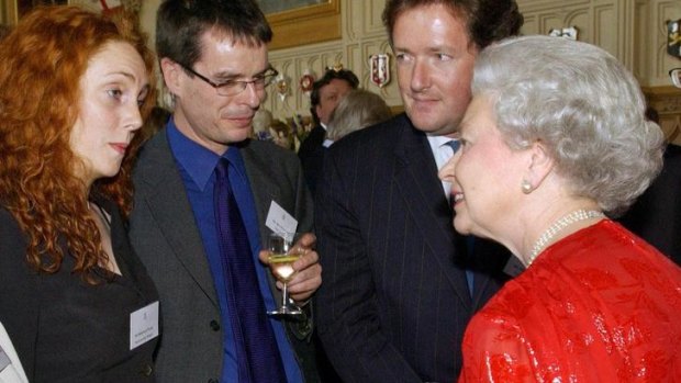 Rebekah Brooks, watched by magazine editor Ben Preston and Piers Morgan, speaks to the Queen during a reception for the media at Windsor Castle in 2002.