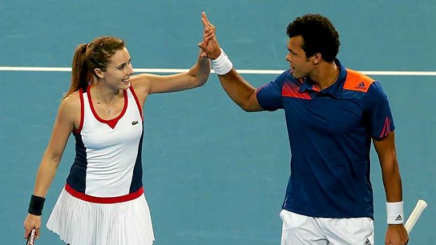 Into the final: Alize Cornet and Jo-Wilfried Tsonga of France celebrate defeating Sloane Stephens and John Isner of the United States in the mixed doubles of the Hopman Cup last night.