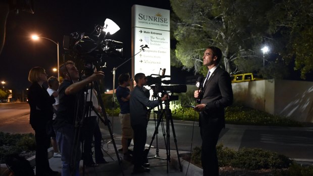 Waiting: Members of the media stand outside Sunrise Hospital and Medical Center in Las Vegas waiting for word about Lamar Odom.