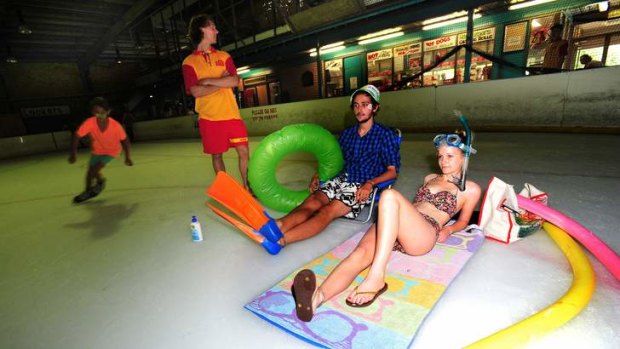 Cooling off at the Phillip skate rink during Canberra's hottest days are Woden swimming pool Lifeguard Rupert Denham, Alex Santiago, 19 of Jerrabomberra and Becky Bollen, 20 of Torrens. (skater is Axel Raut, 10 of Garran)