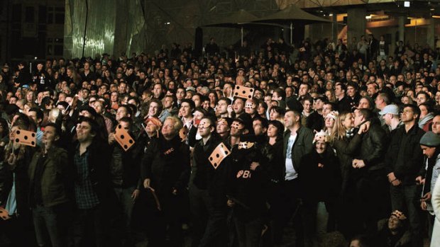 Home crowd … fans of the champion mare cheer her on from Federation Square in Melbourne.