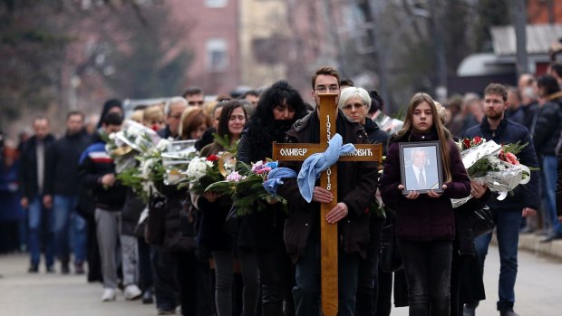 People follow the casket during a final farewell of Kosovo Serb politician Oliver Ivanovic.