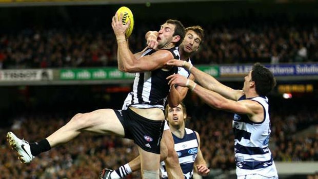 Travis Cloke marks strongly despite the full fist from Corey Enright during Collingwood's round 19 win.
