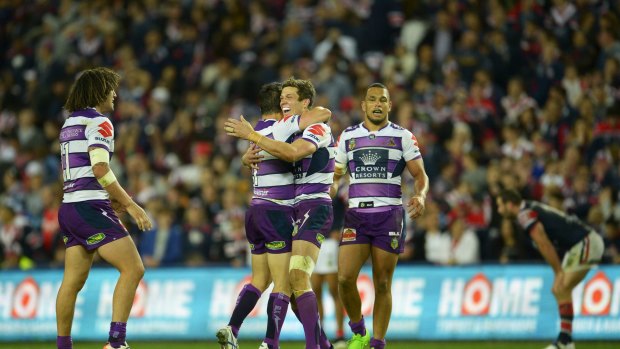 Final fling: Matthew Duffie celebrates victory with Cooper Cronk after the Storm's win over the Roosters.