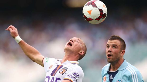 Heading in the right direction: Sydney FC's Matthew Jurman (right) and Perth's Darvydas Sernas contest the ball.