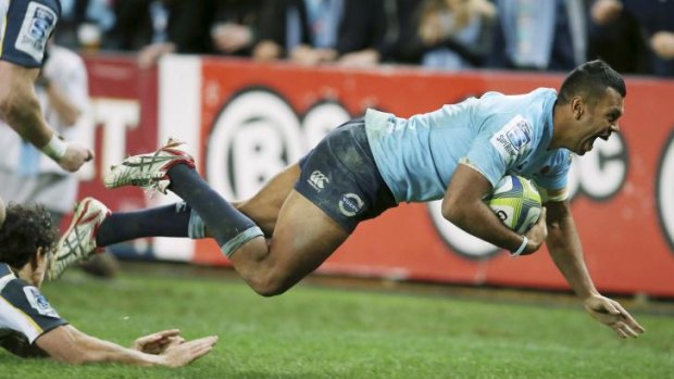 Over he goes: Kurtley Beale is delighted as he dives over to score.