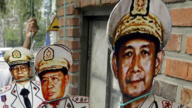 Paper tigers? ... a protester's cut-out pictures of Burmese leaders.