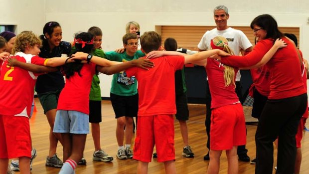 Former Socceroo Craig Foster and Senator Kate Lundy host a Harmony Day indoor soccer match at Forrest Primary school in Canberra last year.