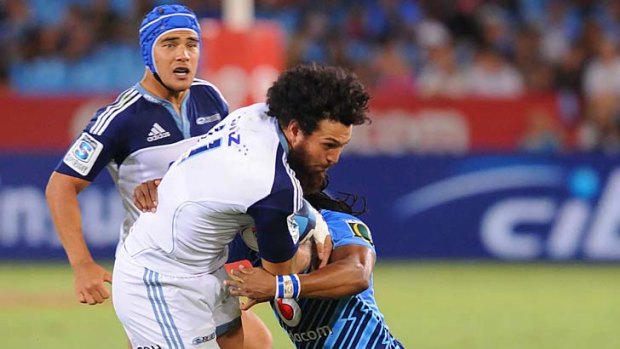 Rene Ranger of the Blues is tackled by Akona Ndungane of the Bulls during Saturday's Super Rugby match.