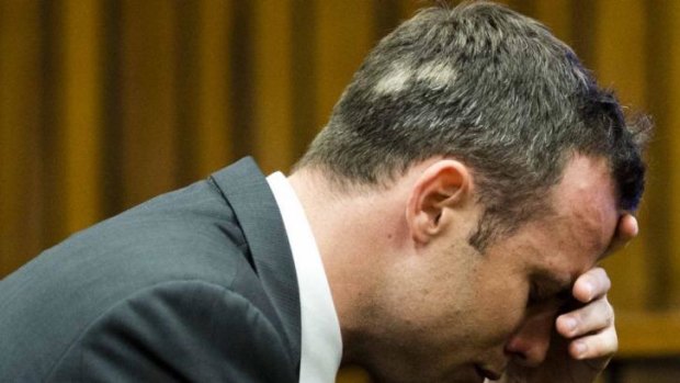 Oscar Pistorius, puts his hand to his face while listening to cross questioning about the events surrounding the shooting death of his girlfriend Reeva Steenkamp, during his trial in March.
