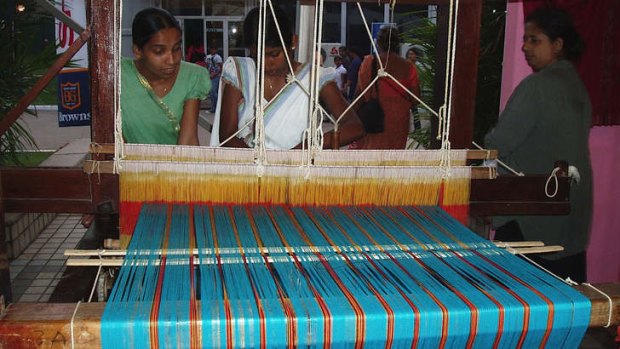 Loom weavers at work.