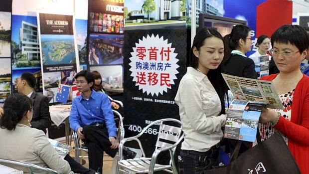Impact overstated: Investors crowd around an Australian real estate booth at a property fair in Beijing.