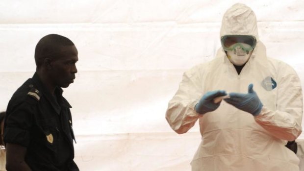 A Senegalese hygienist demonstrates how to protect oneself against the Ebola virus at Dakar airport.