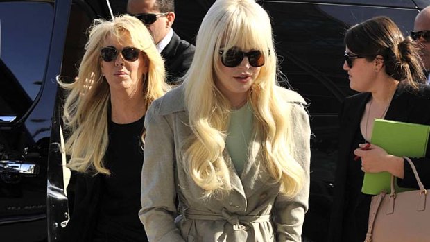 Reported fight ... Lindsay Lohan, centre,and her mother Dina, left.