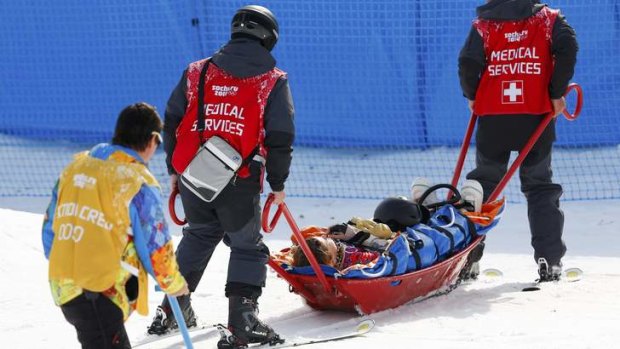 Jacqueline Hernandez of the US is carried off the track on a stretcher after crashing during the women's snowboard cross qualifier.