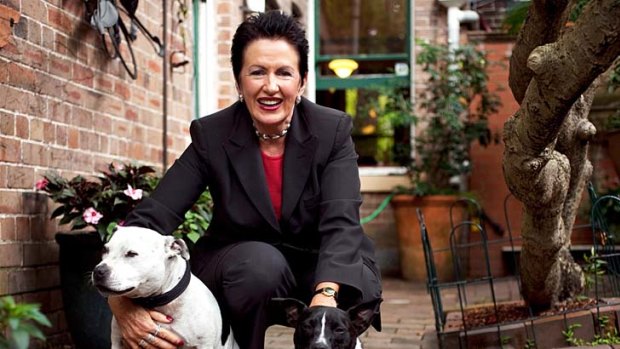 Clover Moore ... in the backyard with her beloved dogs Banjo and Bessie.