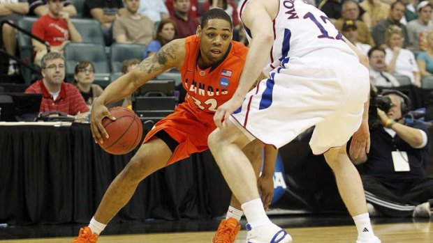 Taipans recruit: Demetri McCamey of Illinois drives with the ball against Kansas Jayhawks during the third round of the 2011 NCAA men's basketball tournament.