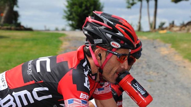 George Hincapie bites his water bottle as he rides in the 189-kilometre eighth stage.