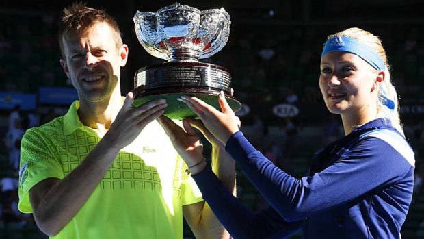Daniel Nestor and Kristina Mladenovic pose with the trophy after defeating Horia Tecau and Sania Mirza.
