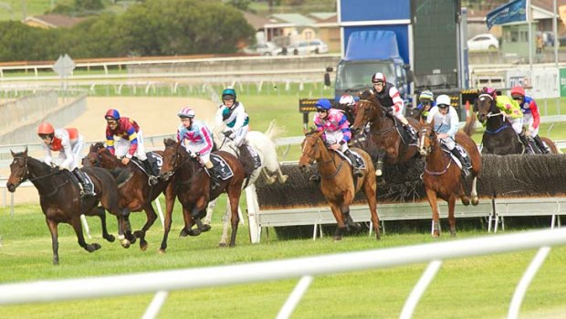 Horses clear the jumps in front of the grandstand during the Grand Annual Steeplechase at Warrnambool.