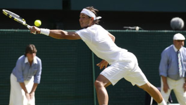 Back in hand .. Spain’s Rafael Nadal reaches out for a return against Japan’s Kei Nishikori during their first-round encounter on Centre Court at Wimbledon.