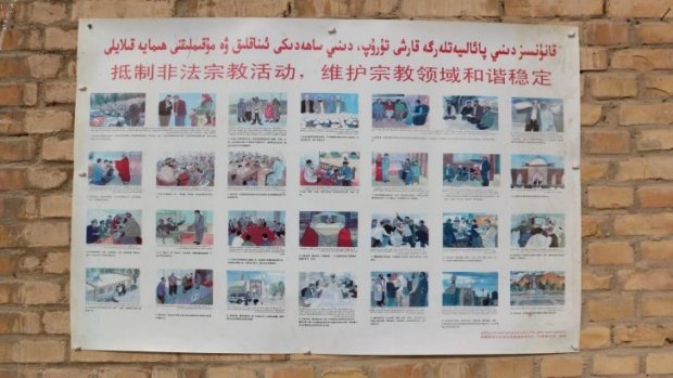 A sign on the side of a village mosque in Xinjiang's Poskam County warns locals not to engage in "illegal religious activities".