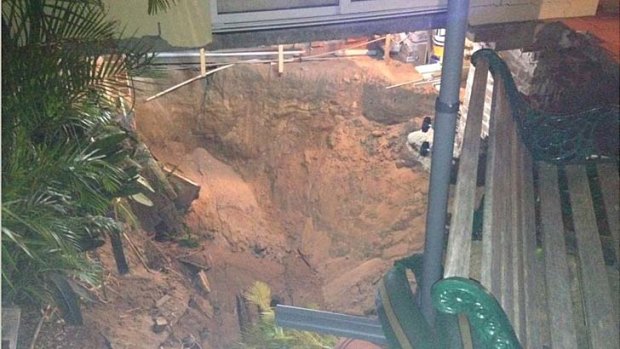 A couple's three-storey home was swallowed by a sinkhole in Swansea.