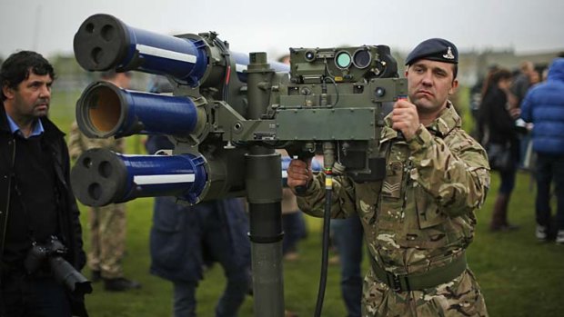 Lock down in East London ... Sergeant Craig from Britain's Royal Artillery regiment holds a high-velocity missile, or HVM, lightweight multiple launcher. The British army will be putting HVM missiles on the roof of Fred Wigg Tower, an apartment building on the outskirts of London, as part of its security during the 2012 Olympics.